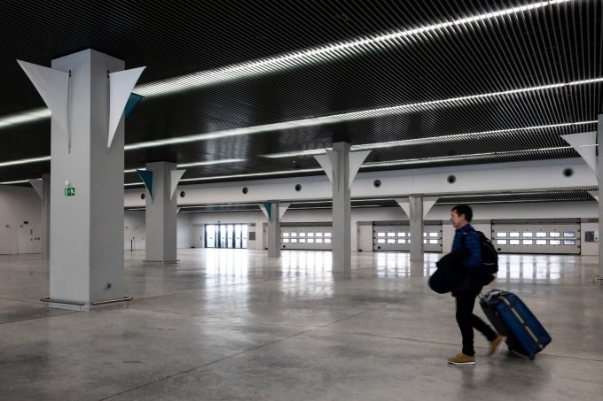 Traveller walking through a modern airport hall