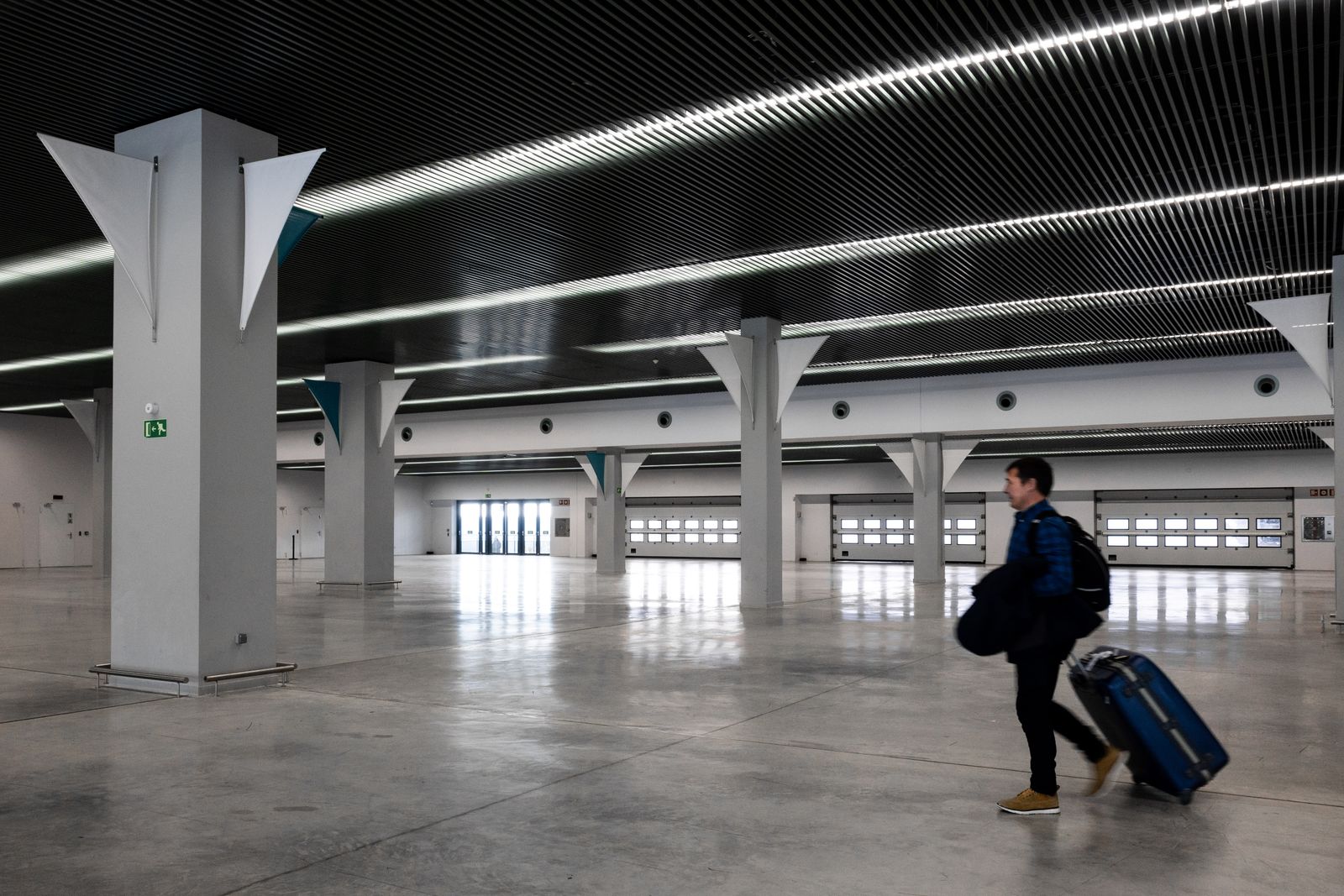 Traveller walking through a modern airport hall