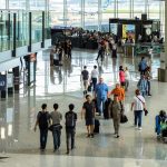Travellers walking through an airport terminal