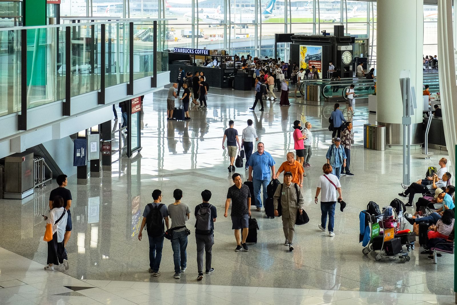 Travellers walking through an airport terminal