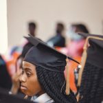University graduate in cap and gown at a graduation ceremony